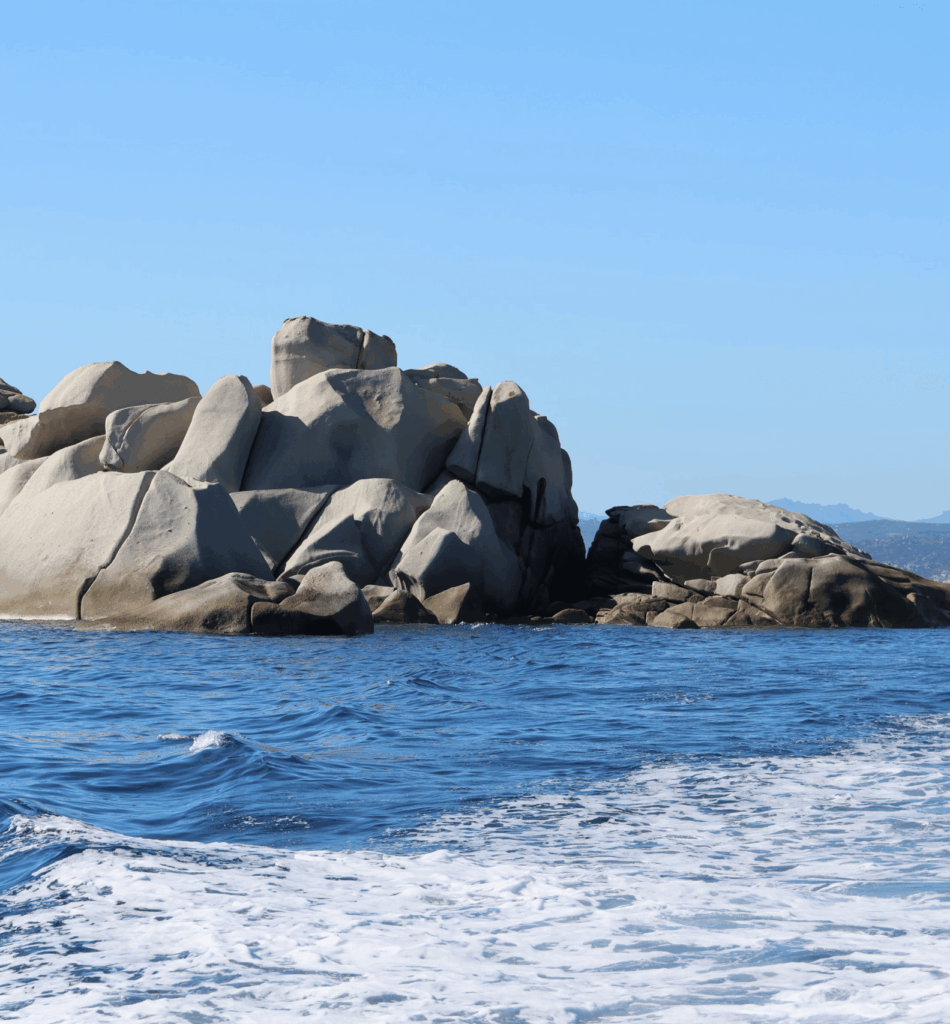 Stunning view of a rocky island in a clear blue sea under a bright sky
